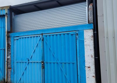 View of the upgraded garage with a new roller shutter and modernized structure.